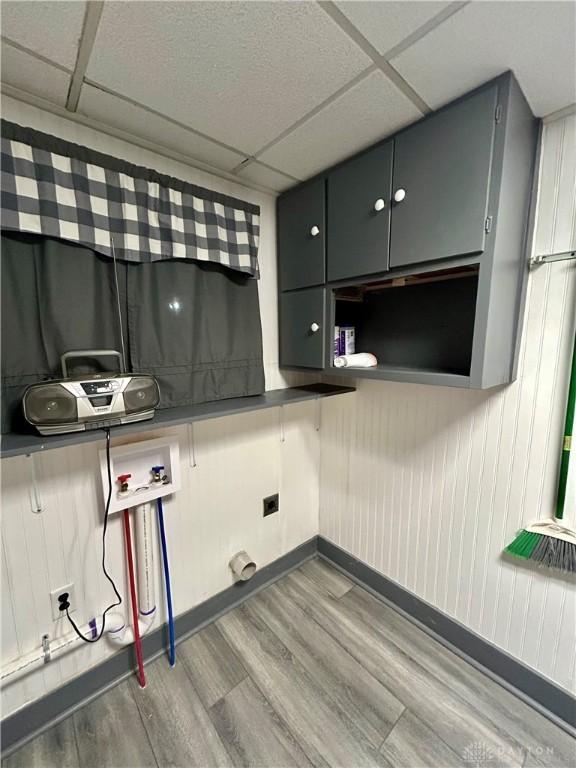 clothes washing area featuring cabinets, washer hookup, and hardwood / wood-style floors