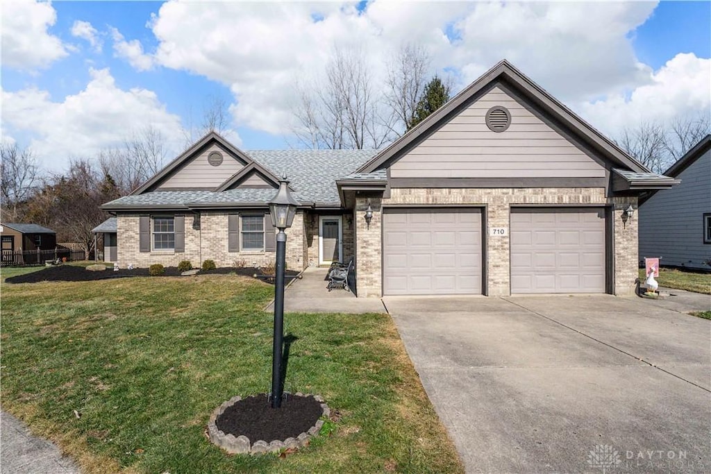 view of front of home with a garage and a front lawn