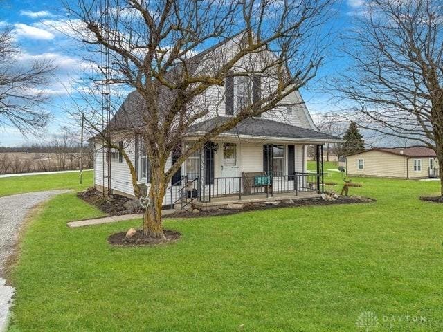 view of front of house featuring a front yard and covered porch