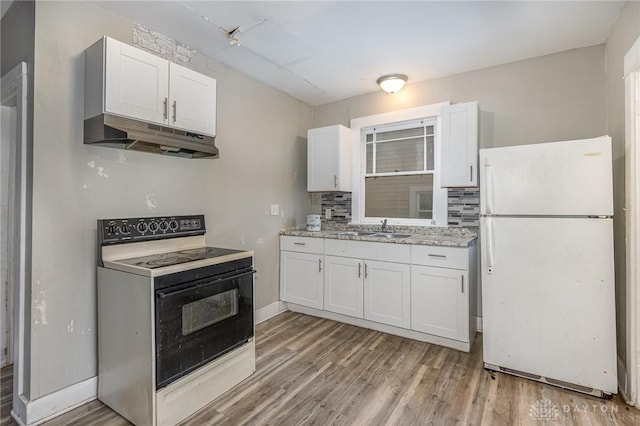 kitchen featuring white cabinets, sink, white fridge, and electric range oven