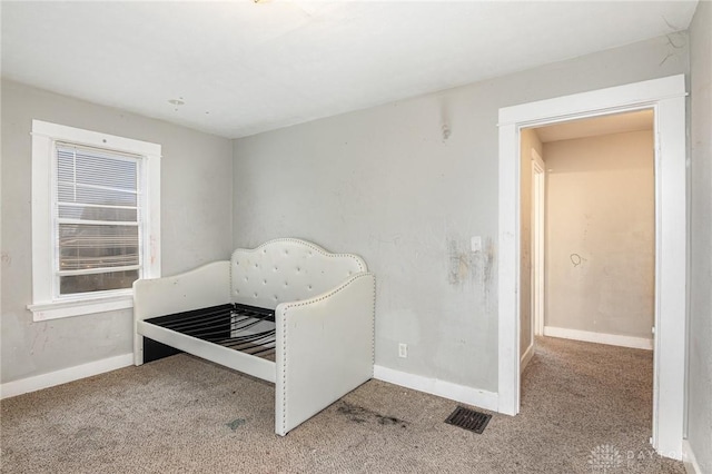 bedroom featuring light colored carpet