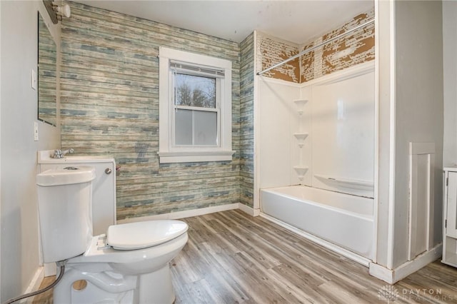 bathroom with shower / bath combination, hardwood / wood-style floors, and toilet