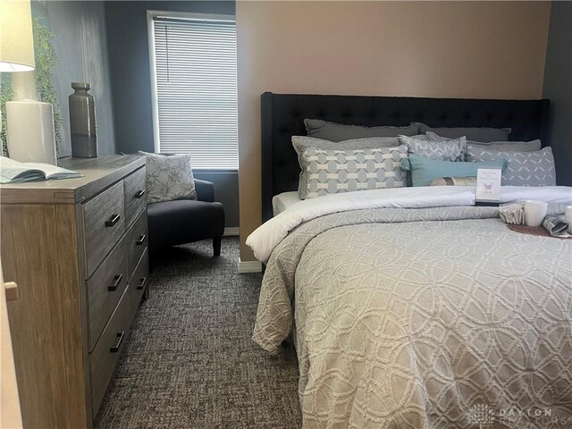 bedroom featuring dark colored carpet