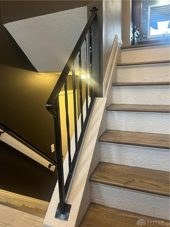 stairway featuring wood-type flooring