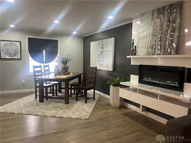 dining space with ornamental molding and dark wood-type flooring