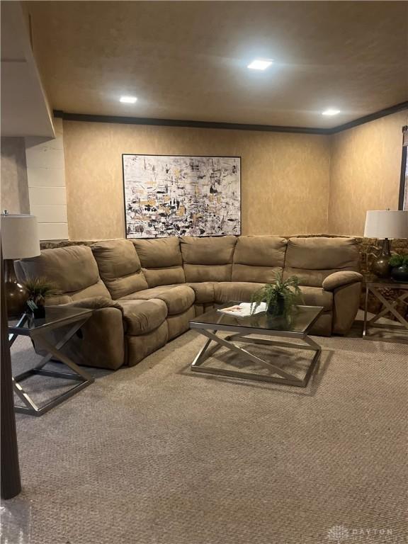 carpeted living room featuring crown molding