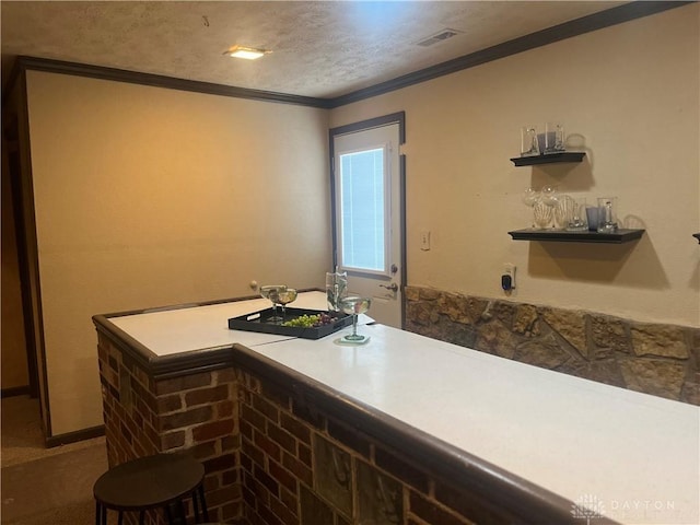 bar featuring bar area, visible vents, and crown molding