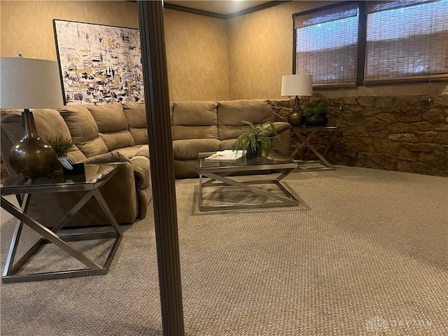 carpeted living area with a textured wall