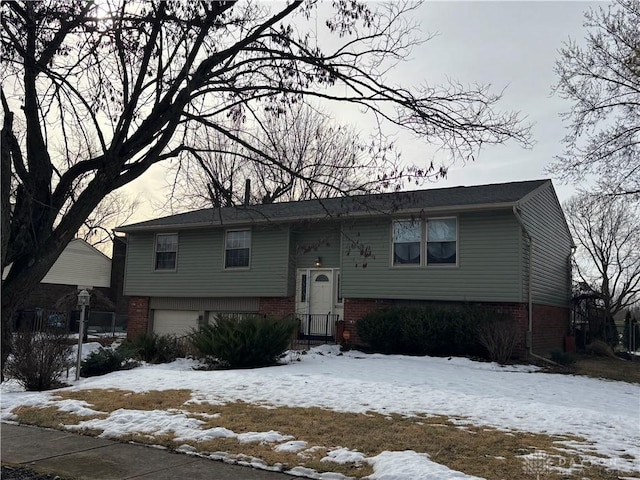 split foyer home with brick siding and an attached garage