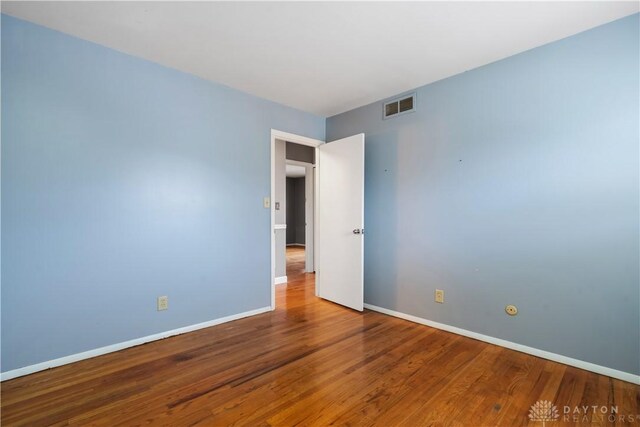 empty room with wood-type flooring