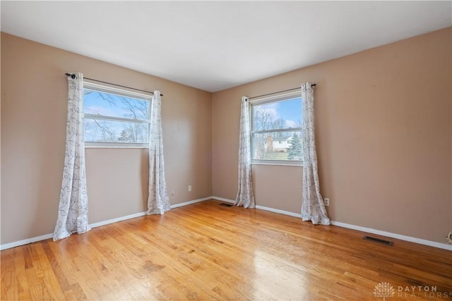 spare room featuring light hardwood / wood-style flooring