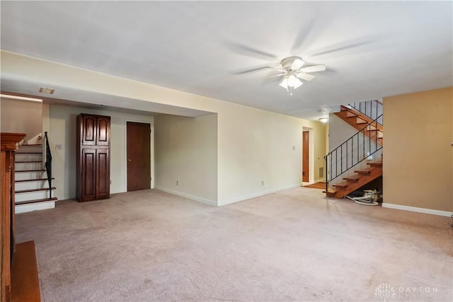 unfurnished living room featuring light colored carpet and ceiling fan