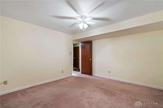 empty room featuring light carpet and ceiling fan