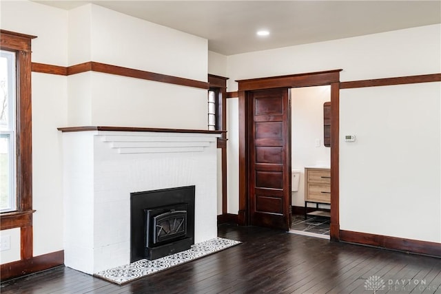 unfurnished living room with dark wood-type flooring