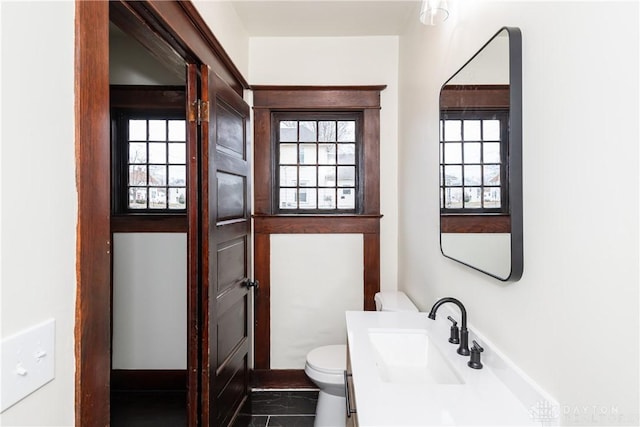 bathroom featuring vanity and toilet