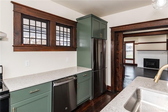 kitchen with range with electric stovetop, black refrigerator, dishwasher, sink, and dark hardwood / wood-style flooring