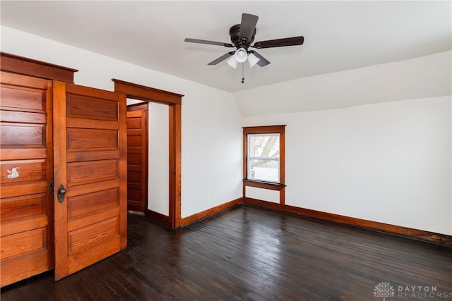 unfurnished bedroom featuring lofted ceiling and dark hardwood / wood-style floors