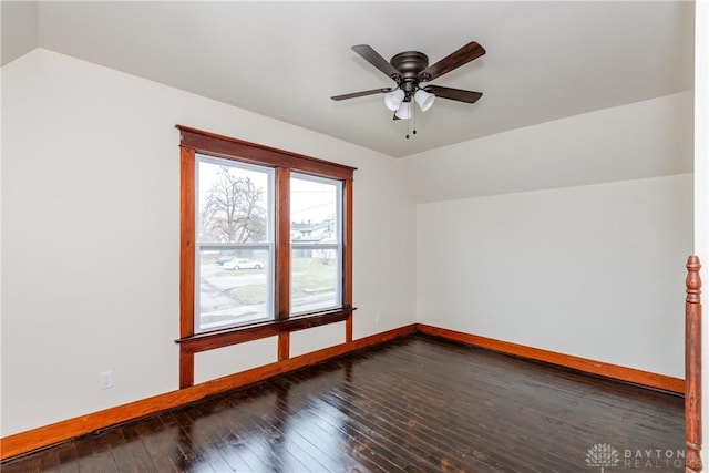 additional living space with vaulted ceiling, dark wood-type flooring, and ceiling fan