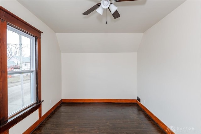 spare room featuring ceiling fan, dark hardwood / wood-style flooring, and vaulted ceiling