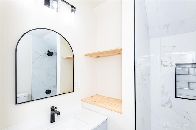 bathroom with vanity and a tile shower