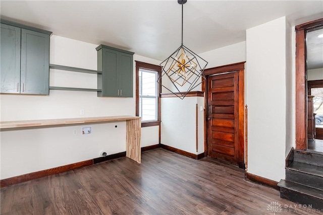 kitchen featuring hanging light fixtures, dark wood-type flooring, and green cabinets