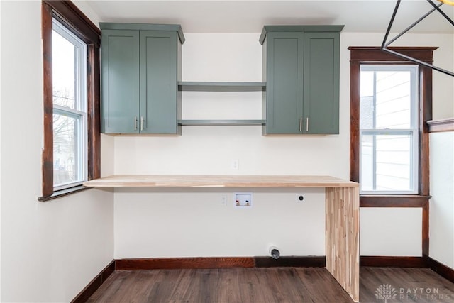 interior space featuring plenty of natural light, green cabinets, and butcher block countertops