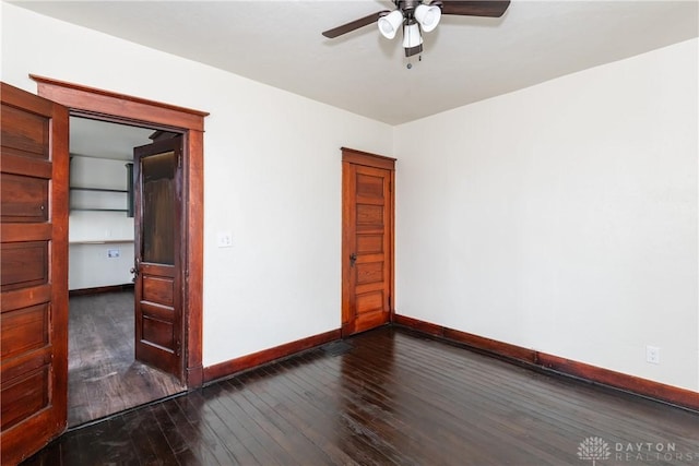 unfurnished room featuring dark hardwood / wood-style floors and ceiling fan