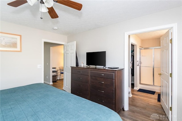 bedroom with wood-type flooring, ceiling fan, and a textured ceiling