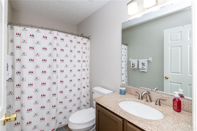 bathroom with a shower with curtain, vanity, toilet, and a textured ceiling