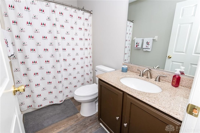 bathroom featuring vanity, hardwood / wood-style floors, toilet, and a shower with shower curtain