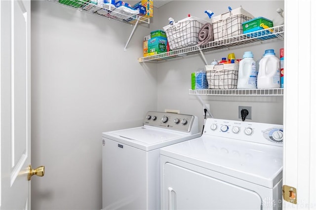 clothes washing area featuring independent washer and dryer