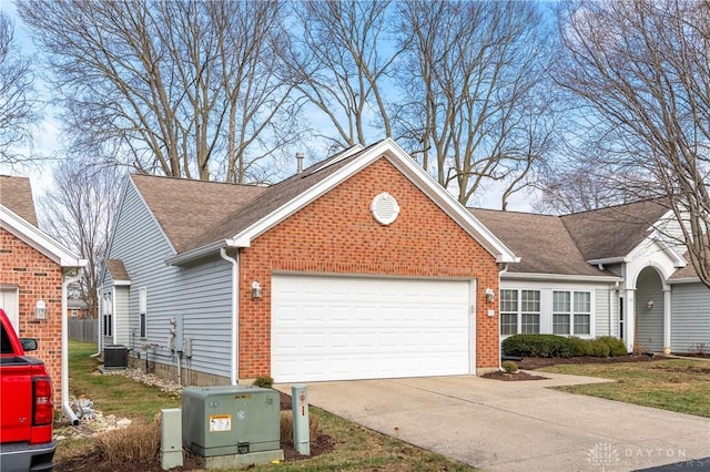 single story home with a garage and central air condition unit