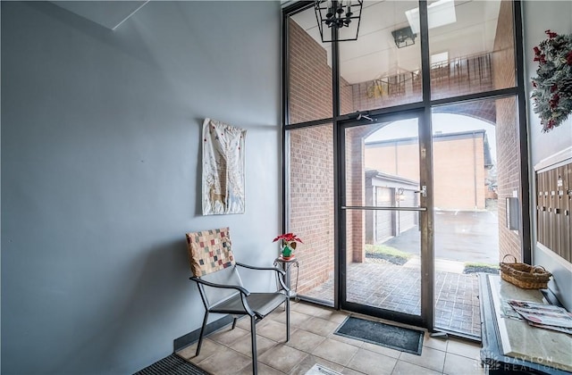 entryway with light tile patterned floors and a high ceiling