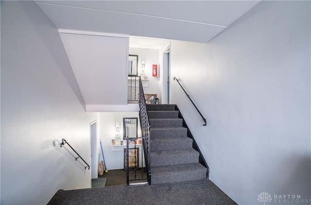 stairs featuring carpet