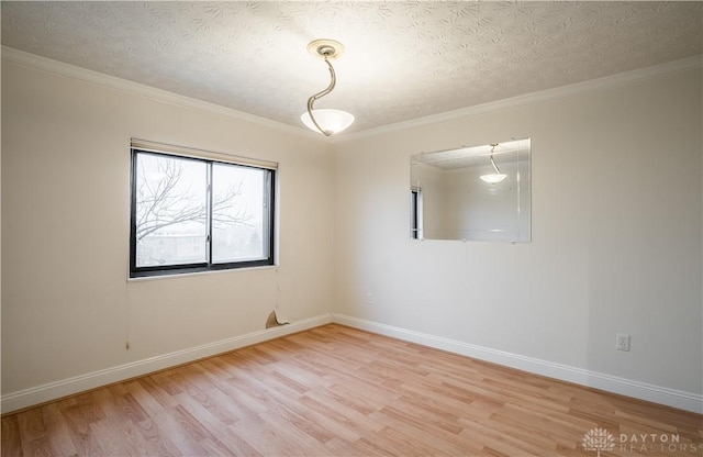 unfurnished room featuring crown molding, hardwood / wood-style flooring, and a textured ceiling