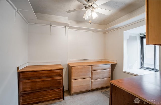 spacious closet with light colored carpet and ceiling fan