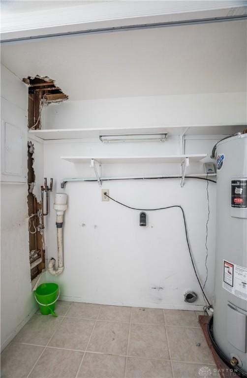 washroom featuring water heater and light tile patterned floors