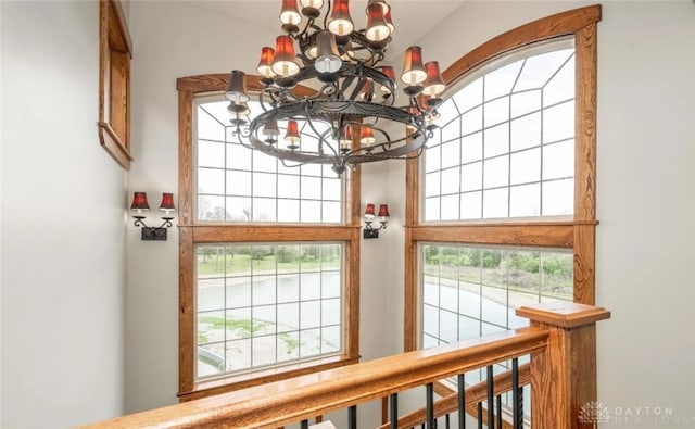 entryway featuring a wealth of natural light and an inviting chandelier