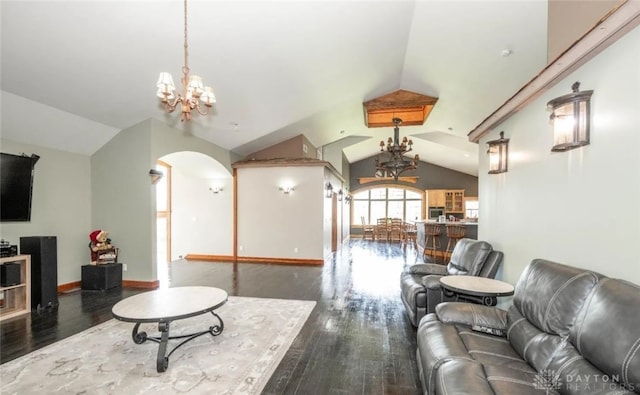 living room with an inviting chandelier, vaulted ceiling, and dark hardwood / wood-style floors