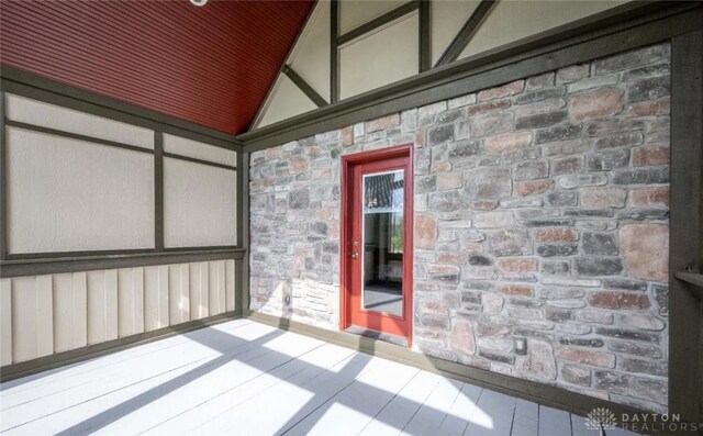 unfurnished sunroom featuring lofted ceiling
