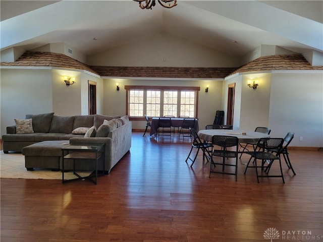 dining room featuring high vaulted ceiling and hardwood / wood-style floors