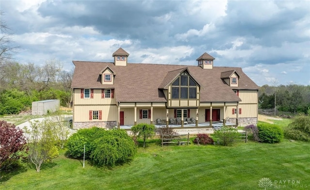 back of house featuring a yard and a patio area