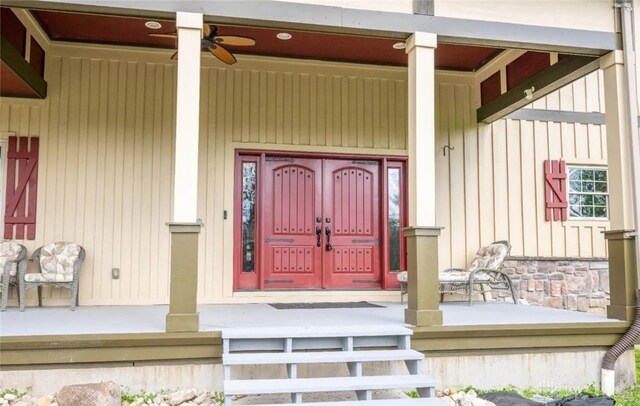 doorway to property featuring a porch and ceiling fan