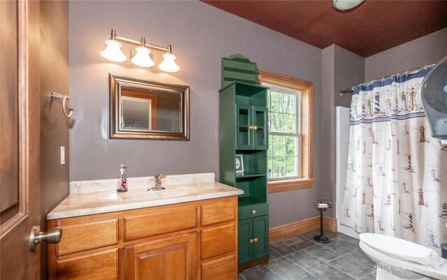 bathroom featuring vanity, tile patterned floors, and toilet