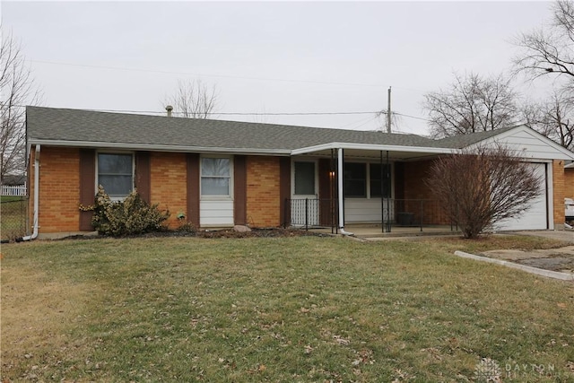 ranch-style home with a front yard, brick siding, and a garage