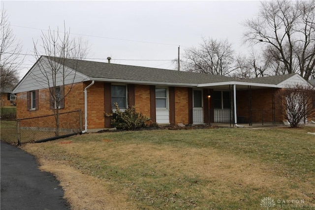 single story home featuring a front yard, covered porch, fence, and brick siding