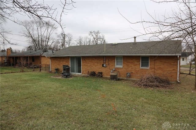 rear view of property featuring a lawn