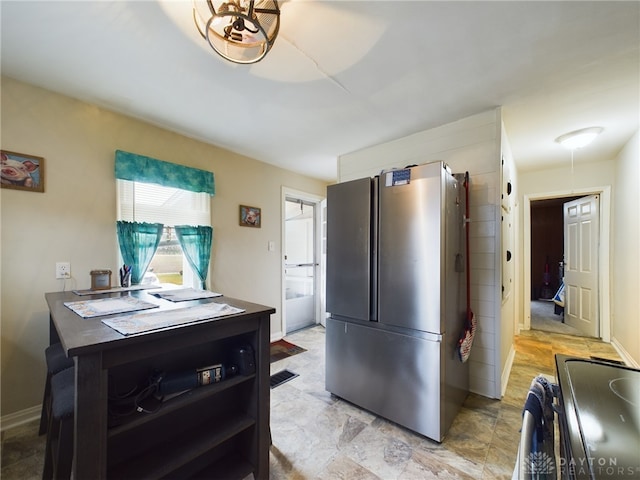 kitchen featuring stainless steel refrigerator and electric range oven