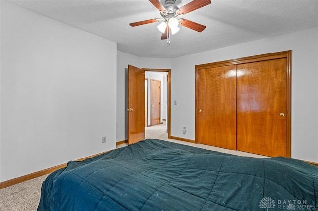 bedroom featuring light carpet, a closet, and ceiling fan