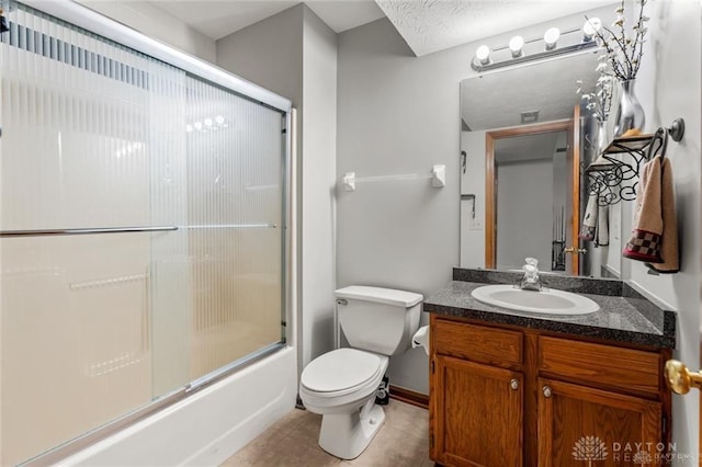 full bathroom featuring vanity, bath / shower combo with glass door, tile patterned floors, and toilet